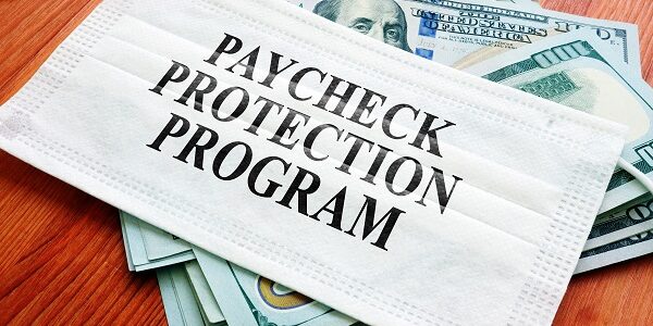 PPP Paycheck Protection Program as SBA loan written on the mask and money.