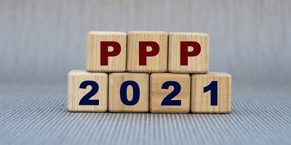 PPP 2021 – word on wooden cubes on a gray background